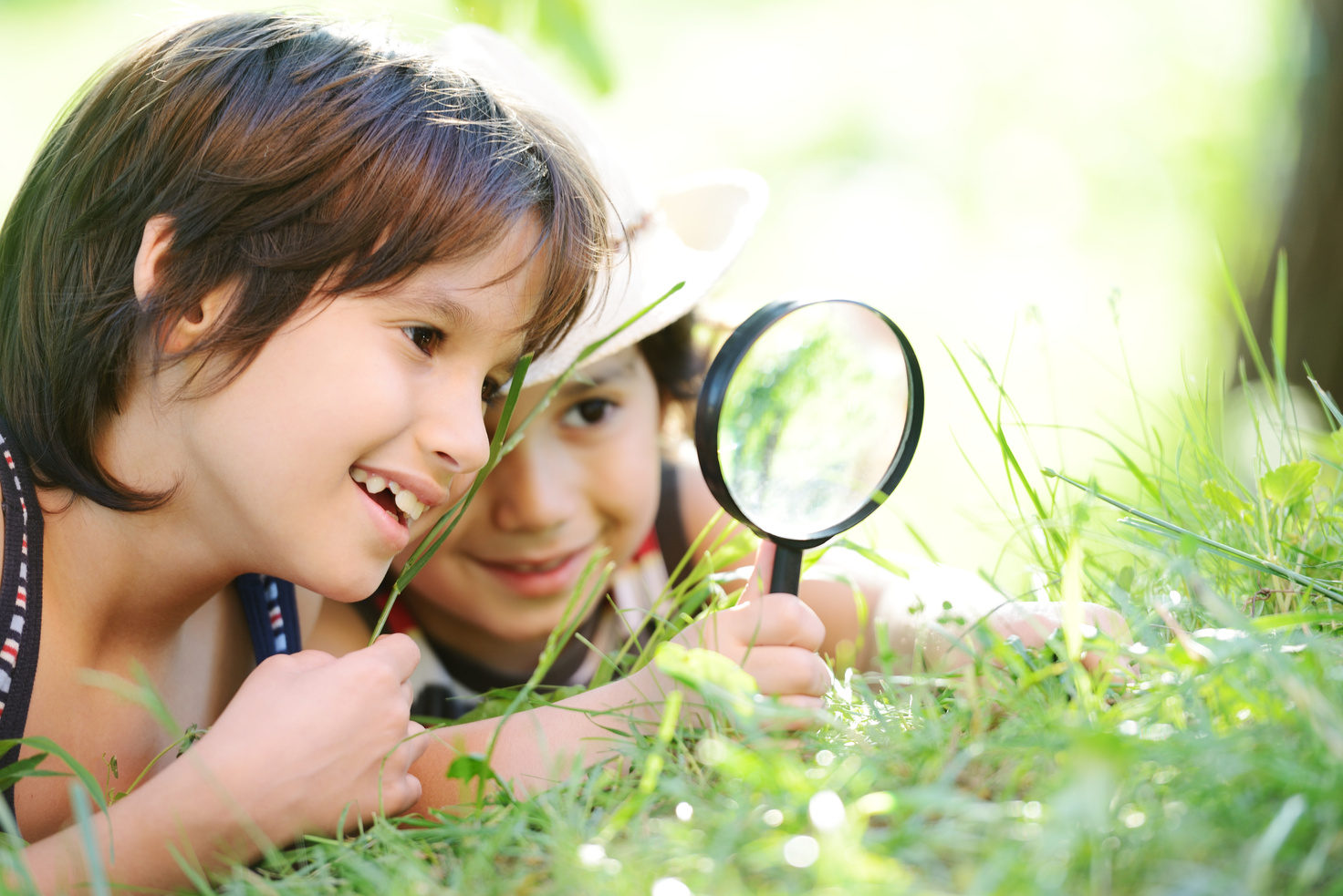 Happy Kid Exploring Nature with Magnifying Glass