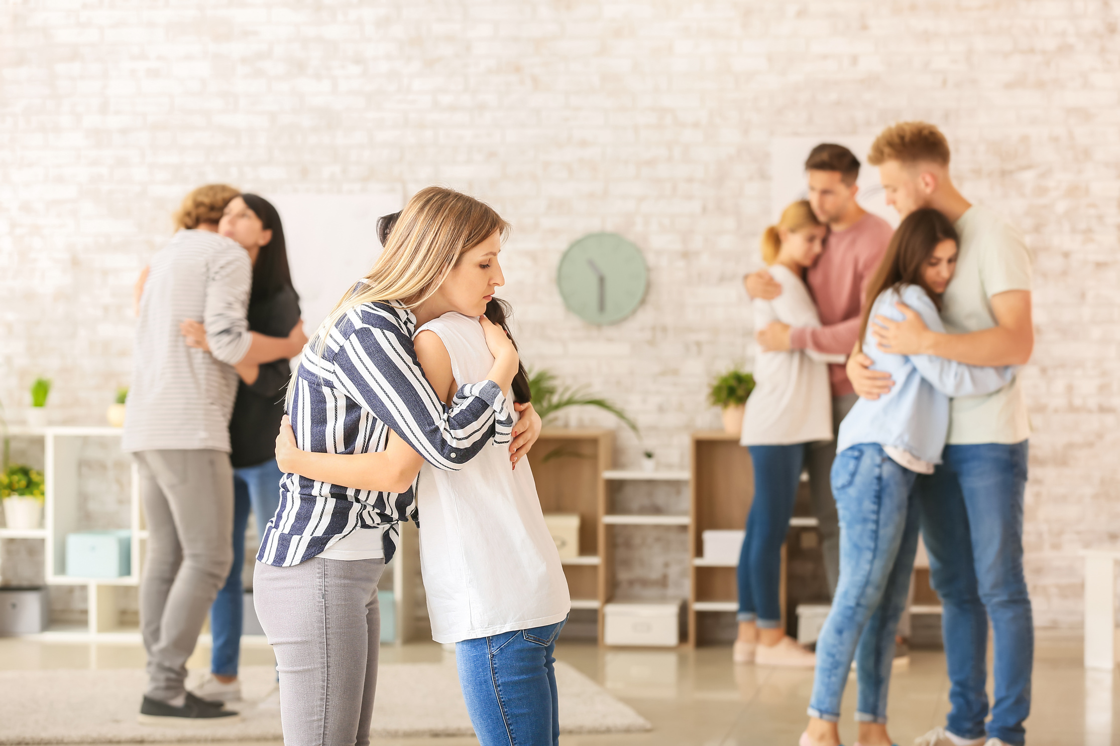 People Hugging at Group Therapy Session